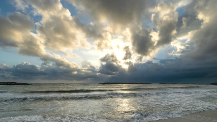 Naklejka na ściany i meble Sand, sea and clouds at sunrise