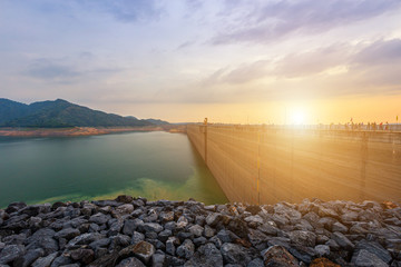 view of the river and mountains on Khun Dan Prakan Chon dam is largest and longest roller compacted concrete dam in the world during sunset in Nakonnarok Thailand.