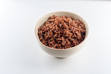 Cooked prep red quinoa in a bowl. Top view.