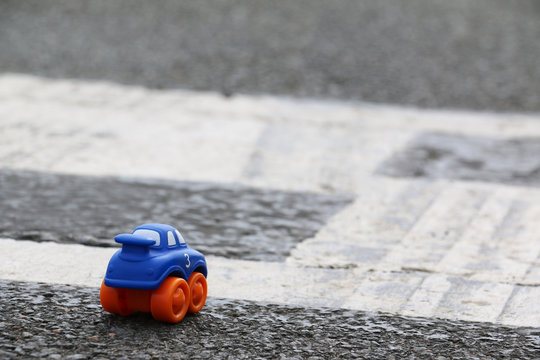 Little Adventurer - Toy Car On A Race Track (Albert Park Circuit, Melbourne). Creative Stock Photo