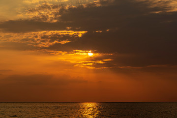 Colorful sunset over calm sea water near tropical beach. Summer vacation concept. Island Phangan, Thailand