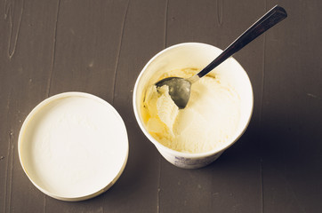 Fototapeta na wymiar ice cream. ice cream in jar on a dark table. Spoon on ice cream. Sweet dessert. Top view