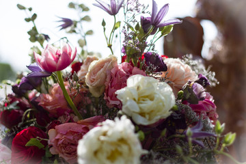 composition of pink and red roses on a blurred background.