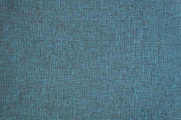 Light blue background from a textile material. Fabric with natural texture. Cloth backdrop