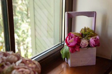 decorative box with flowers on the windowsill, interior decor.