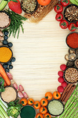 Fototapeta na wymiar Liver detox super food background with fresh fruit, vegetables, herbs, spices and herbal medicine. Health foods high in antioxidants, anthocaynins, vitamins & dietary fibre. Top view on bamboo.