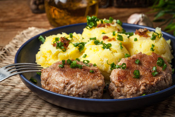 Meatballs served with boiled potatoes.