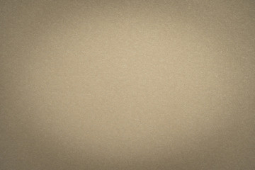 Abstract beige glossy paper texture background or backdrop. Empty light brown cardboard or shiny paperboard for decorative design element. Simple grainy surface for journal template presentation