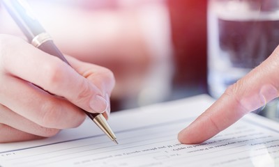 Male Hand Pointing a Place to Sign a Paper