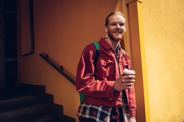 Young hipster man staying with cup of coffee