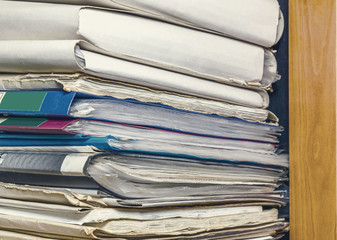 Old paper document folders stacked