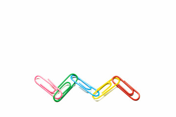 Colorful paper clips on white background with close up view.