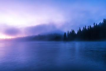 Stunning image of the foggy lake. Dramatic morning sunrise scene. 