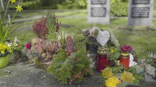 Fresh flowers offering on a tomb in the cemetery, remembering a departed love one.