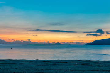 Colorful sky at amazing dawn over ocean on beach