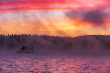 Fototapeta na wymiar Stunning image of the foggy lake. Dramatic morning sunrise scene. 