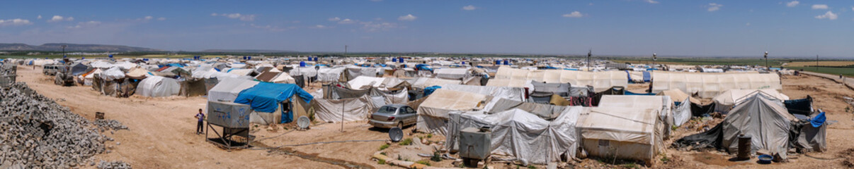 AZEZ, SYRIA – MAY 19: Refugee camp for syrian people in Burseya hill on May 19, 2019 in Azez, Syria. In the civil war that began in Syria in 2011, 12 million people were displaced. - obrazy, fototapety, plakaty