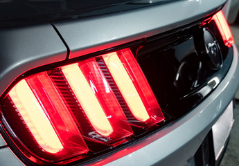 Bangkok -Thailand  May 28, 2019: The tail light of a silver 2015 50th Anniversary Ford Mustang with...