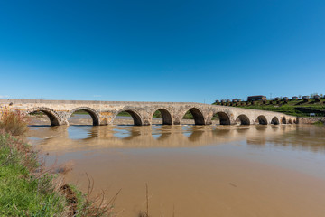 Fototapeta na wymiar Old historic bridge over the Euphrates River. Turkey.