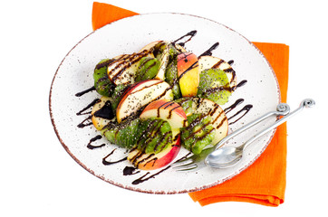 Fruit dessert from apples, kiwi, chia with chocolate topping