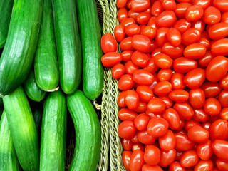 Heap of whole tomatoes and cucumbers. Top view point.
