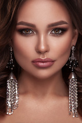 Beauty portrait of model with natural make-up. Fashion shiny highlighter on skin, sexy gloss lips make-up