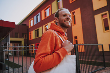 Young hipster man with eco bag on walk
