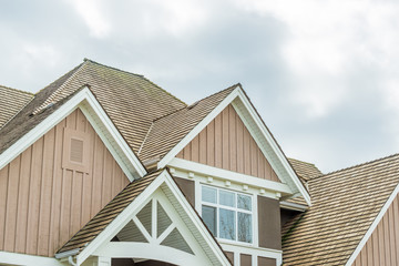 The top of the house or apartment building with nice window.
