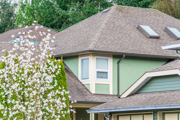 The top of the house or apartment building with nice window.