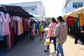  Many people are walking in the morning market to take blurred photos