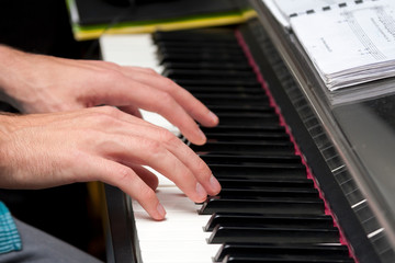 Obraz premium Hands playing on piano, keyboardHands playing on piano, keyboard, composing, home recording / studio concept