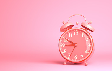 Alarm clock on the pink background