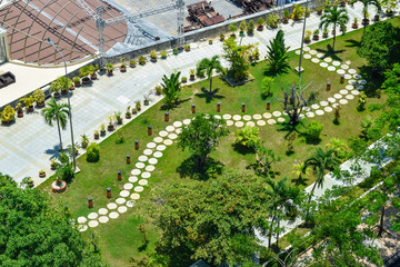 Aerial view at path of stone on lawn in tropical park