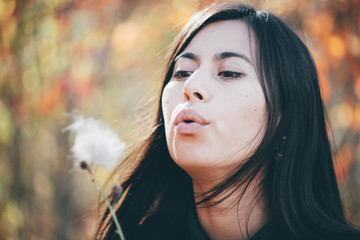 Female beauty portrait surrounded by vivid foliage. Dreamy beautiful girl with long natural black...