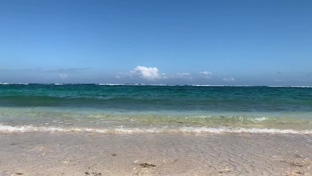 Beautiful 4K Nature with tropical sea and beach on white cloud and blue sky at Bali beach in Indonesia.