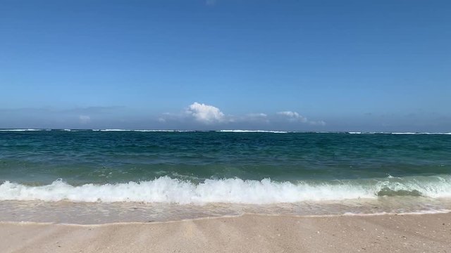 Beautiful 4K Nature with tropical sea and beach on white cloud and blue sky at Bali beach in Indonesia.
