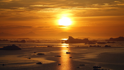 Fototapeta premium Sunset on icebergs in Arctic Ocean