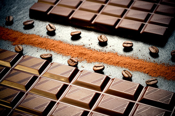 Black chocolate bar, coffee beans, cocoa powder