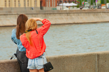 Russia. Moscow. May 26, 2019. Krymskaya Embankment. The embankment is pedestrian. Two girls make a photo.