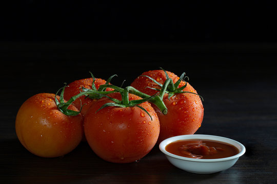 Fresh Tomato And Ketchup In White Bowl On Dim Light Background