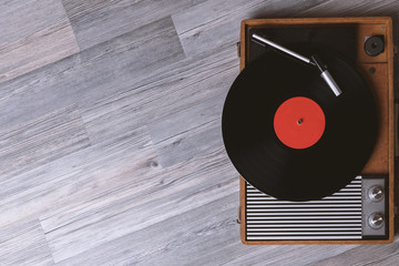Turntable vinyl record player on the background of their gray wooden boards. Needle on a vinyl...