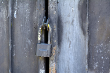 hanging rusty lock on the iron gate. Concept - closed space. Vintage