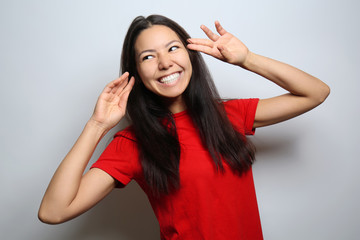 Fototapeta premium Attractive young woman posing on light background