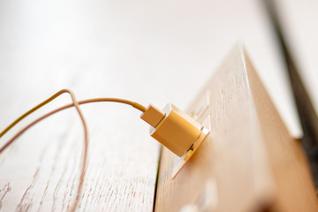 Smart phone charger plugging in power outlet