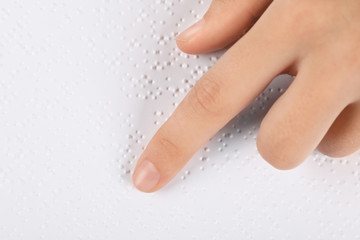 Blind person reading book written in Braille, closeup