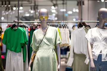 Fashion clothes putting on mannequin displaying in front the shop