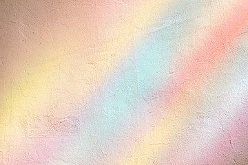 Plastered wall in the colorful sunlight rays from stained glass window