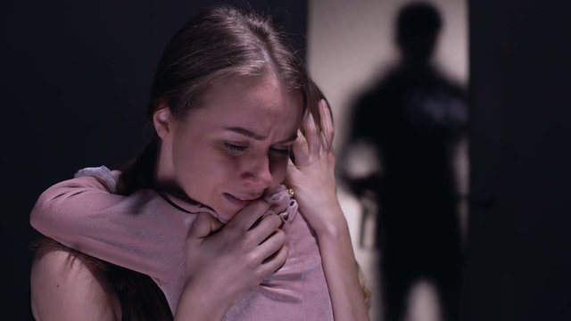 Defenseless woman hugging child, drunkard male with bottle entering room, fear