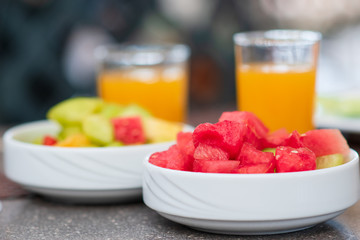 Continental breakfast with fresh croissant, orange juice and fruits, selective focus