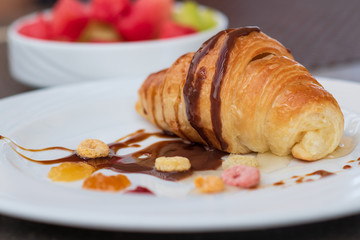 Continental breakfast with fresh croissant, orange juice and fruits, selective focus